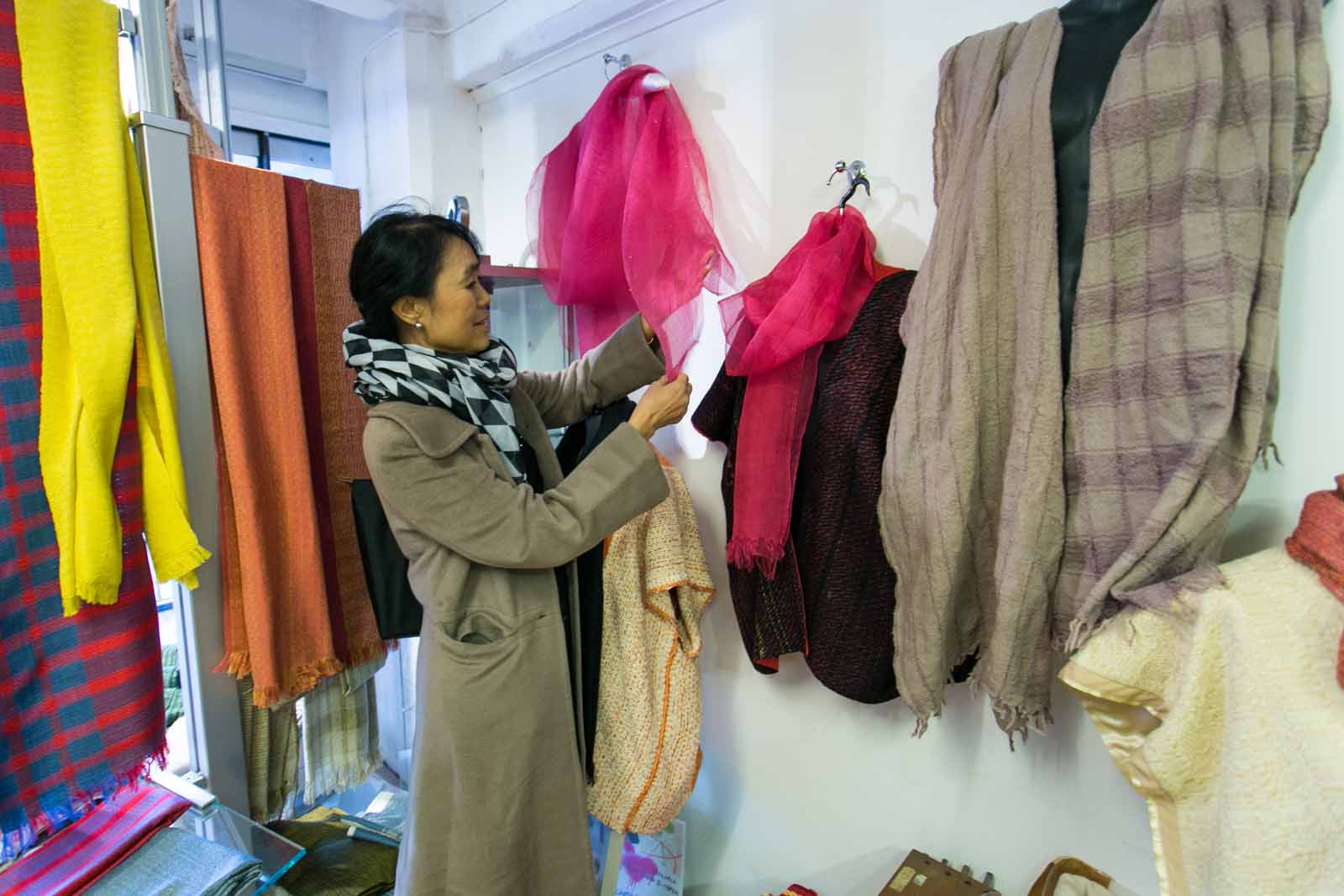 Daw Khine inspects garments in a textiles social enterprise