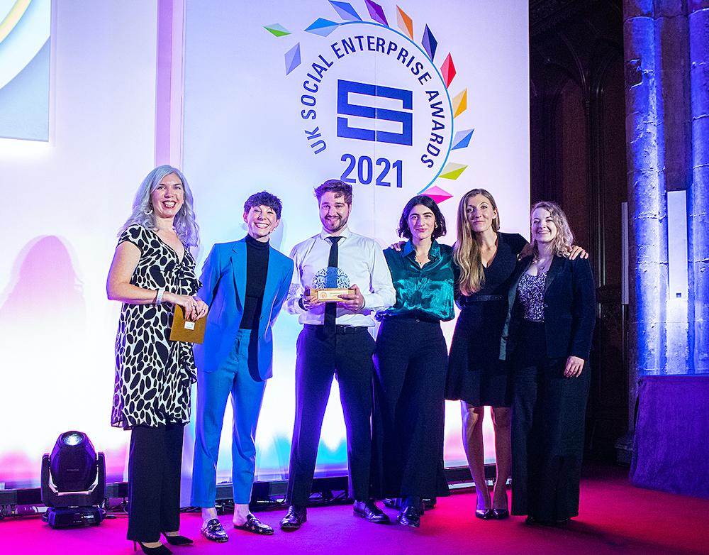 Members of the Auticon UK team accepting their International Impact Award from the British Council's Paula Woodman (left) at the Social Enterprise UK ceremony in December 2021