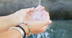 woman's hands with clean water splashing