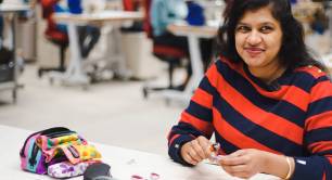 Photo of woman making key rings in workshop