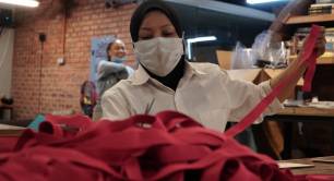 A volunteer makes face shields at the Biji biji Initiative in Malaysia