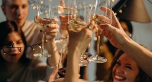 People holding up champagne glasses