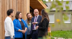 Scottish first minister John Swinney making coffee in a house made by social enterprise Social Bite