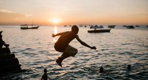 Boy jumping into water by Julia Volk on Pexels