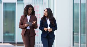 Businesswomen walking with tablet