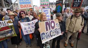 Protesters hold up anti-AI placards outside Scottish parliament