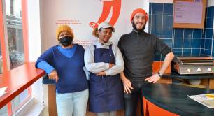 Three of Trampoline's staff members standing inside their cafe in north London