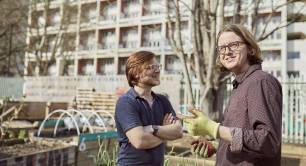 two men standing in front of a building