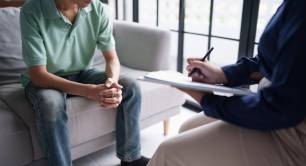 Professional psychotherapy taking note during appointment patient 