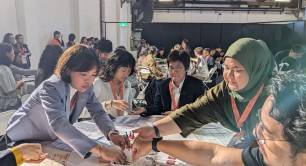 SEWF delegates play B Lab board game