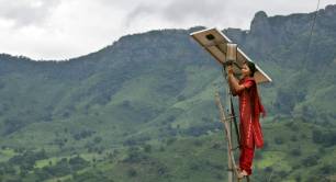 A female engineer setting up a solar panel in India