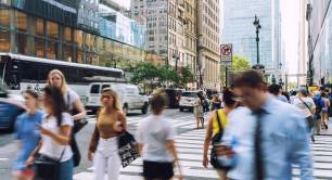 people crossing a road in a city