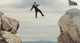 man in suit walks on tightrope