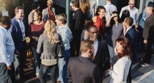 A group of people networking at an event (stock image)