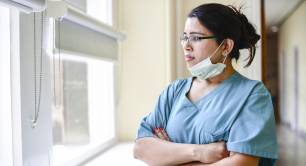 Female nurse staring out window
