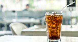 a glass of iced cola on a table