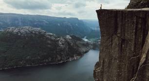 man with yellow jacket poses top rock