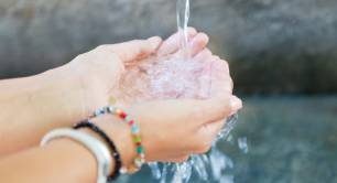 woman's hands with clean water splashing